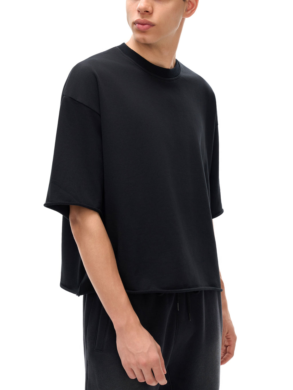 Unisex French Terry Raw-Edge T-Shirt in Black - model angled view