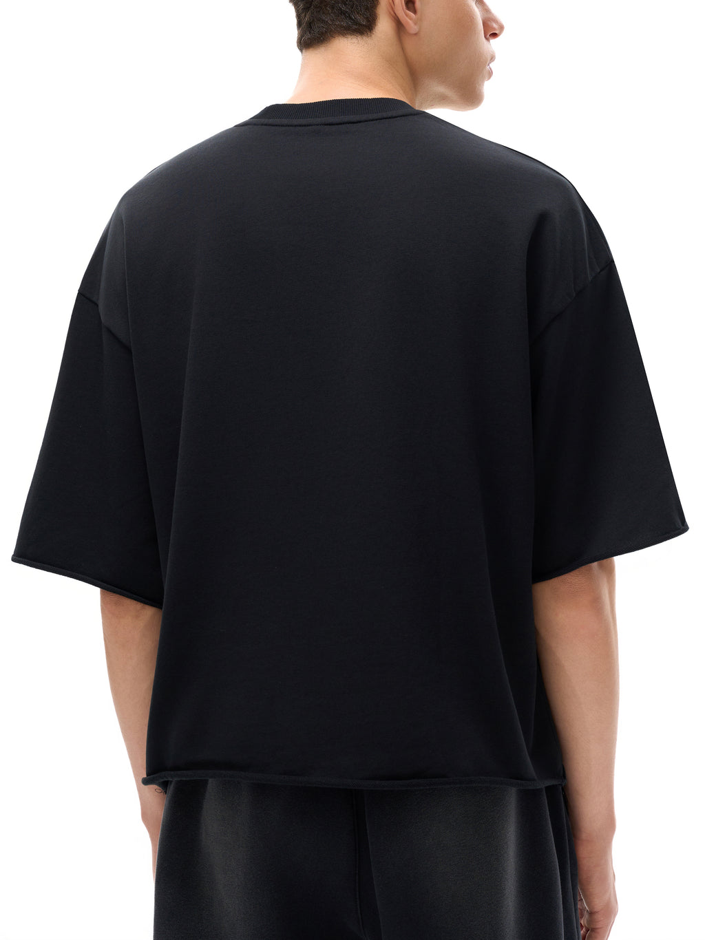 Unisex French Terry Raw-Edge T-Shirt in Black - model rear angled view